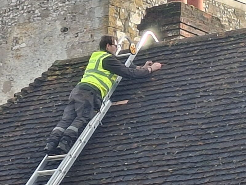 Minor repairs to a aged clay tile roof